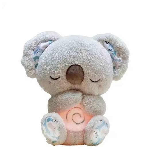 Peluche Koala que respira, material suave, incluye sonidos y luz relajante.